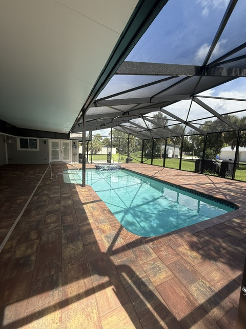 after 13 Paver patio surrounding a pool in a screened enclosure, showcasing Elite Pavers Solutions' craftsmanship in Southwest Florida outdoor renovations.