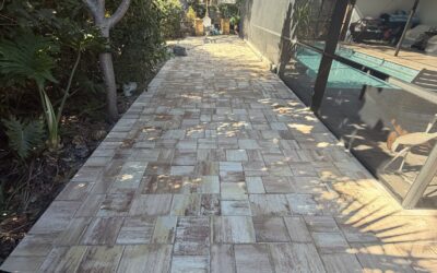 Paver walkway leading to a pool area, showcasing expertly installed pavers in a Southwest Florida residential setting, emphasizing outdoor aesthetics and functionality.